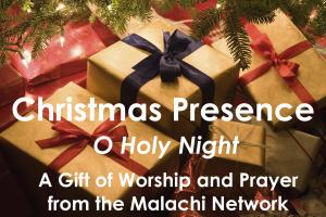 Christmas presents piled underneath a christmas tree.